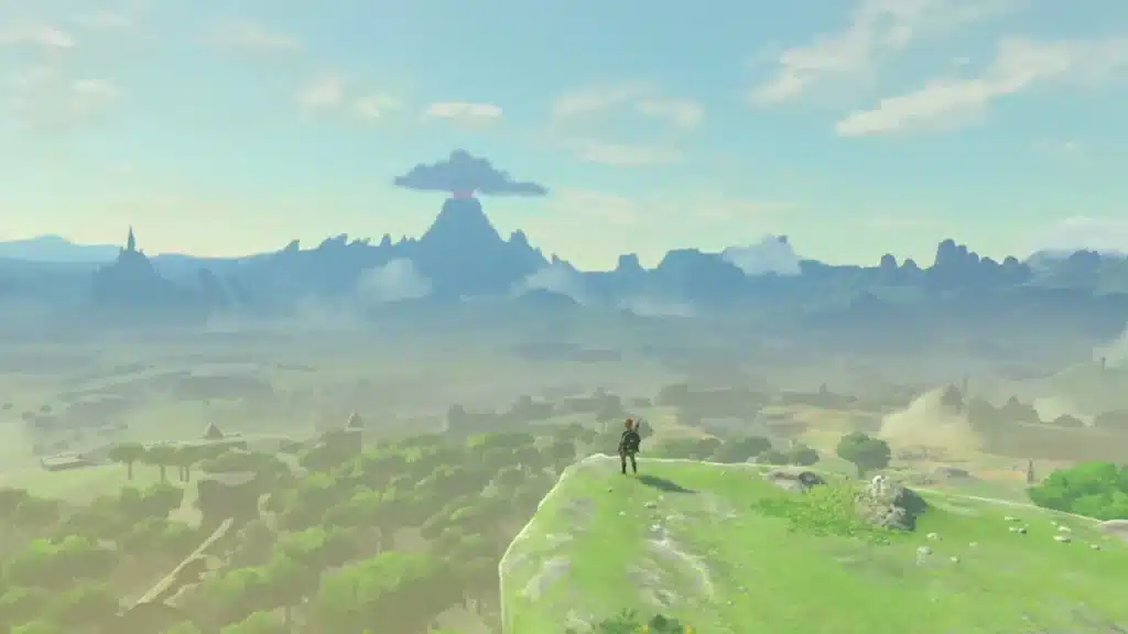 Link standing on a grassy hill overlooking Hyrule Field with Hyrule Castle and Death Mountain in the distance