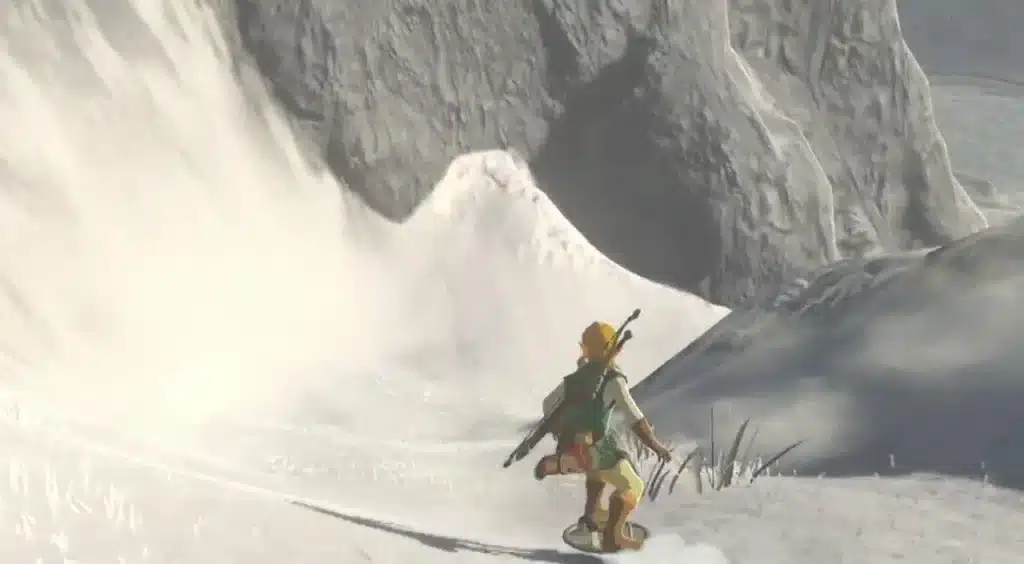 Link shield surfing down a snowy mountain slope in Breath of the Wild