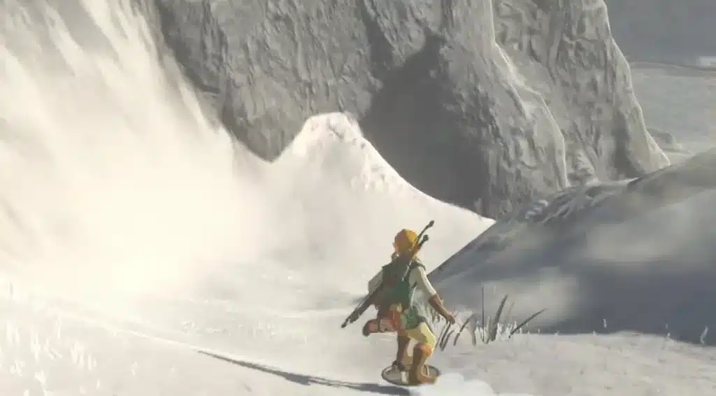 Link shield surfing down a snowy mountain slope in Breath of the Wild