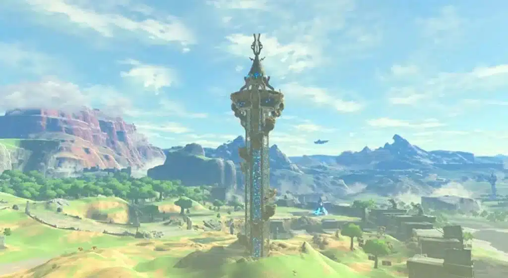A Sheikah Tower glowing blue on a grassy hill with red cliffs behind it in Breath of the Wild