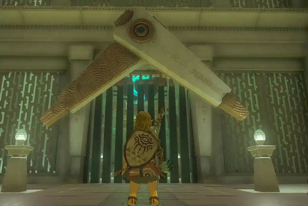 Link standing before the green barred gate inside a shrine in Tears of the Kingdom