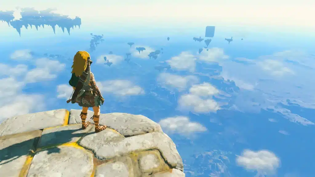 Link standing on the edge of a sky island looking out over floating islands and clouds in Tears of the Kingdom