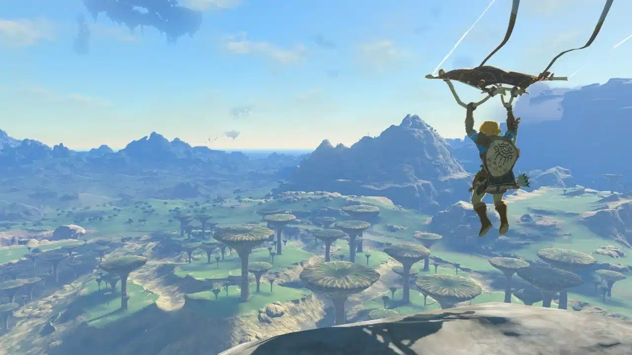 Link gliding off a high rock over a plain in Tears of the Kingdom